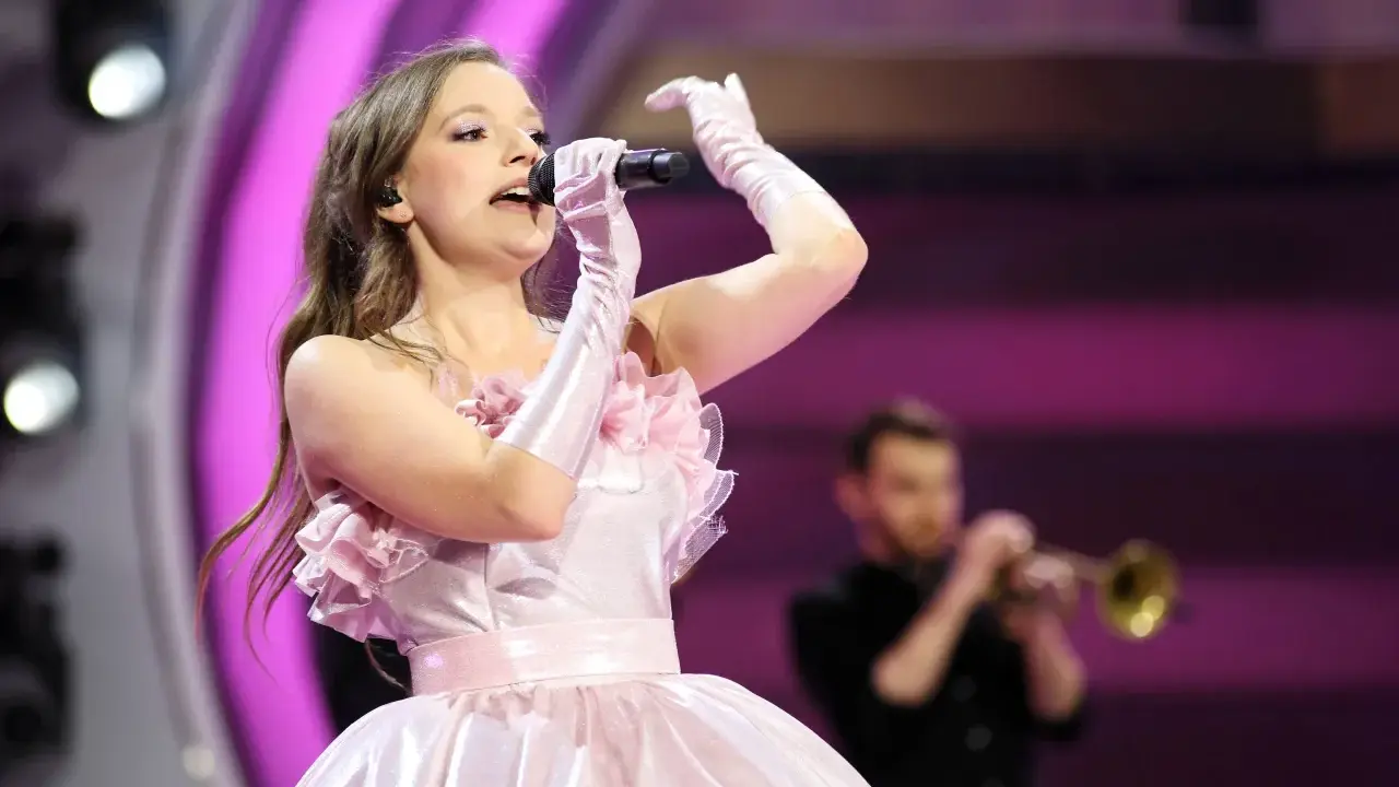 Sanah w różowej sukni śpiewa na koncercie w Łodzi. Czy wiesz, ile trwa koncert sanah łódź?