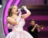Sanah w różowej sukni śpiewa na koncercie w Łodzi. Czy wiesz, ile trwa koncert sanah łódź?