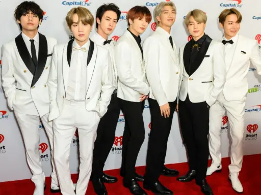 Siedmiu członków BTS w białych garniturach na czerwonym dywanie. Zastanawiasz się, ile kosztuje bilet na koncert BTS?